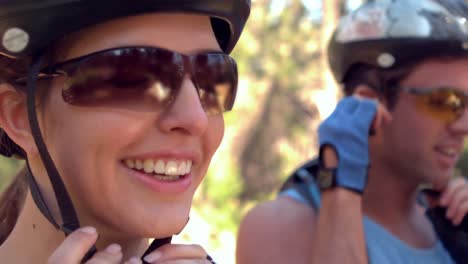 smiling couple wearing helmet