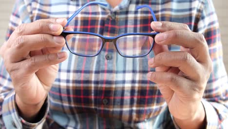 person holding eyeglasses