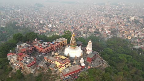 aerial drone shot of monkey temple in kathmandu, nepal at the base of the himalayas