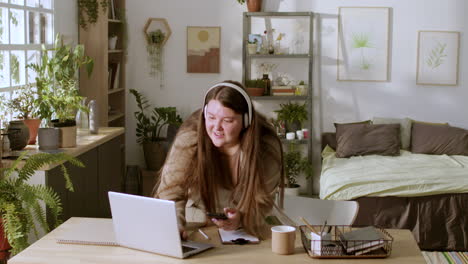 young woman listening to music with headphones