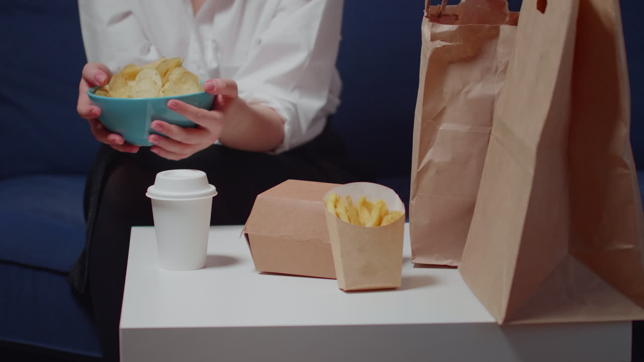 Close up of caucasian hands holding bowl of chips