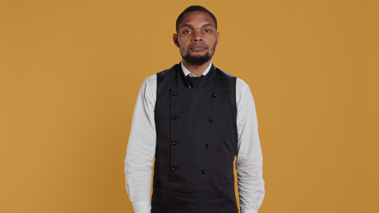 레스토랑 직원 들 은 노란색 배경 에 대해 엄지손가락 을 내려 놓은 표지판 을 내놓는다