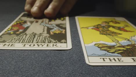 Close-Up-Shot-Of-Person-Giving-Tarot-Card-Reading-Laying-Down-Cards-On-Table-With-Candles-And-Crystals-2