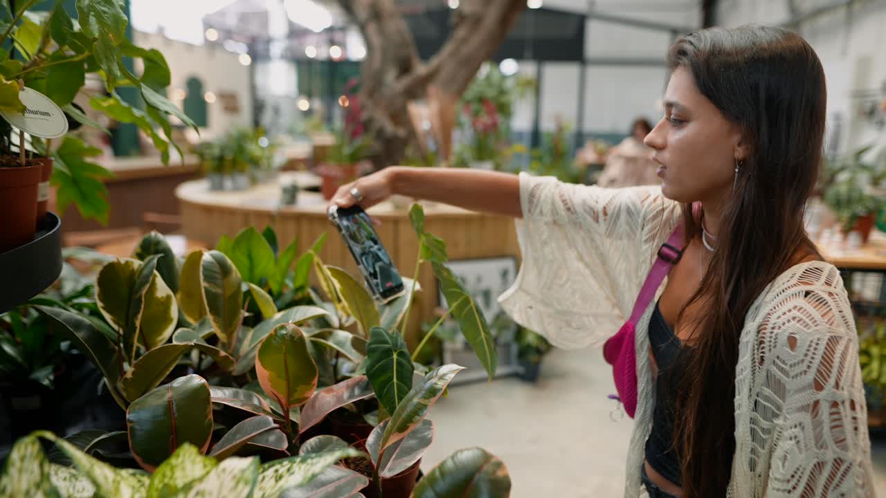 Woman taking pictures of plants in a botanical garden
