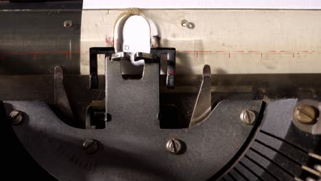 vintage typewriter types words on paper in a detailed close-up of keys and movement