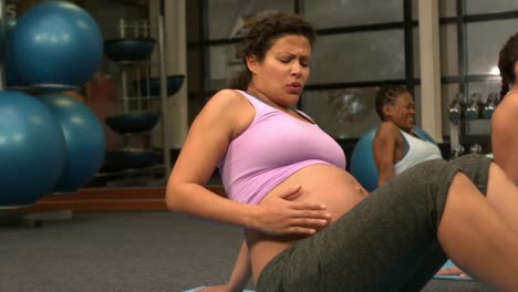 pregnant women exercising at the gym