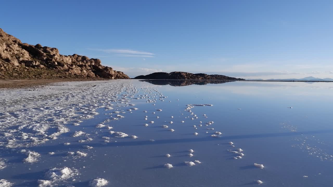 Pan to glassy reflective surface of Uyuni Salt lake, Bolivian plateau