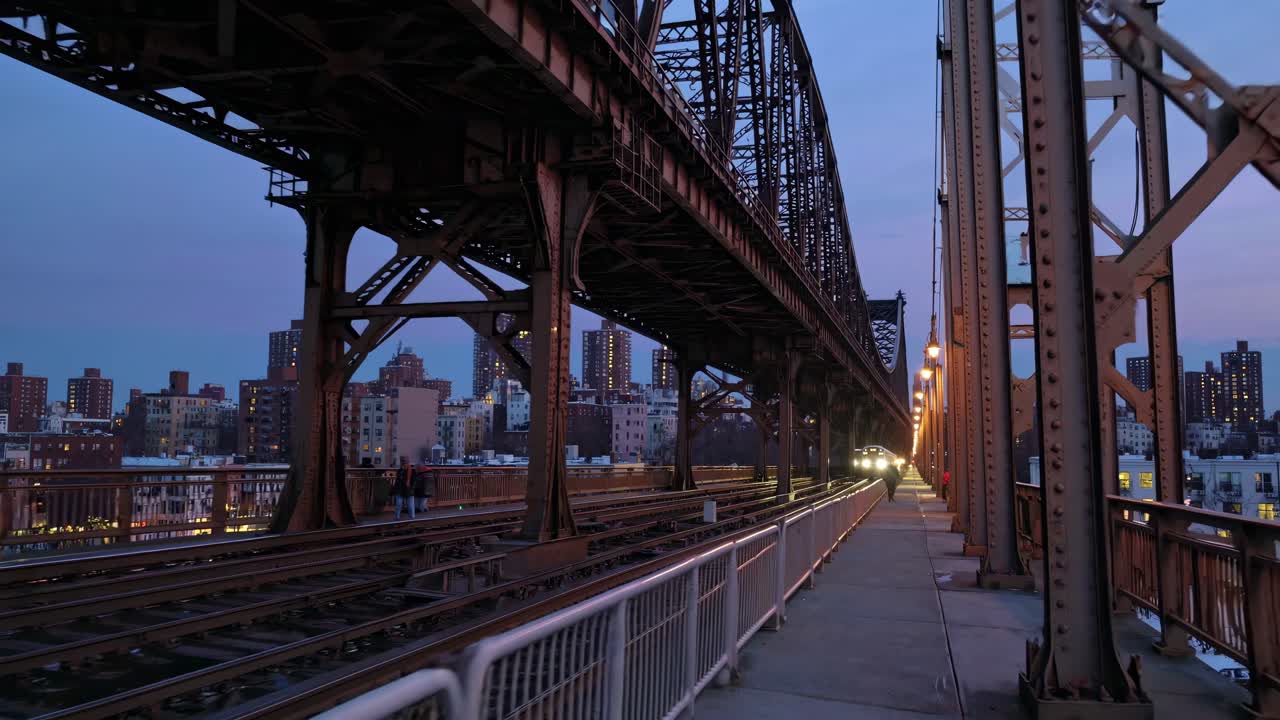 Urban video scene capturing a low-angle view of a bridge at dusk, highlighting industrial