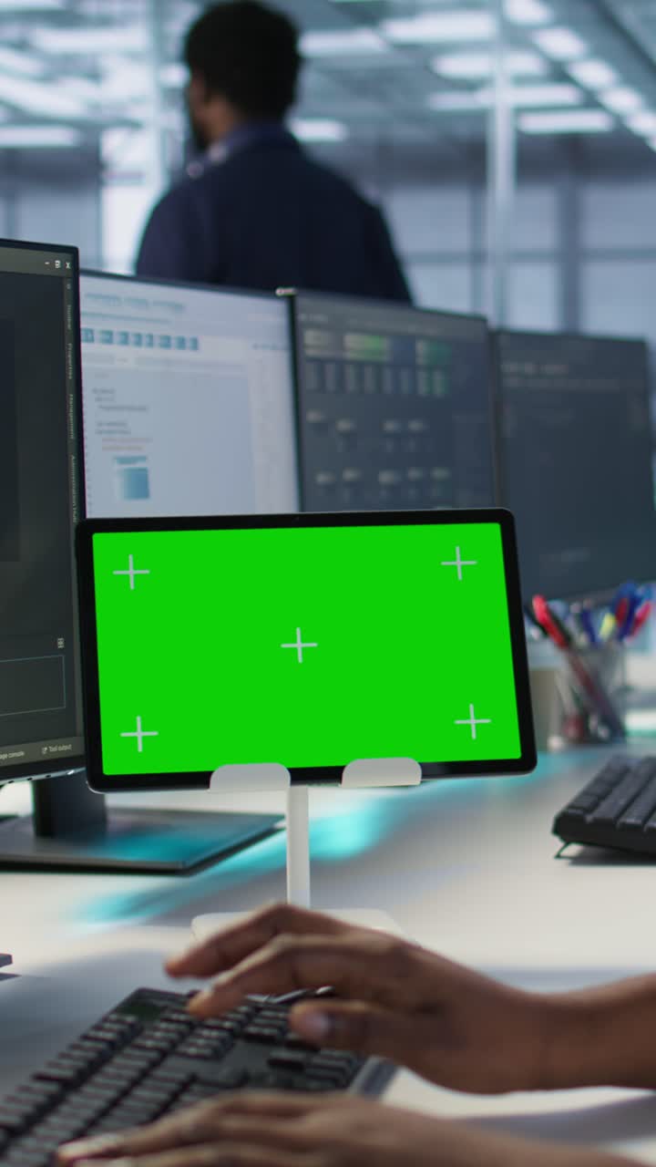 Vertical video System administrator using isolated screen tablet, working in server farm