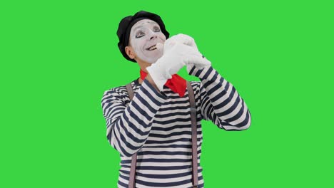 mime sosteniendo tocando pared imaginaria y haciendo pájaro imaginario en una pantalla verde, llave de croma