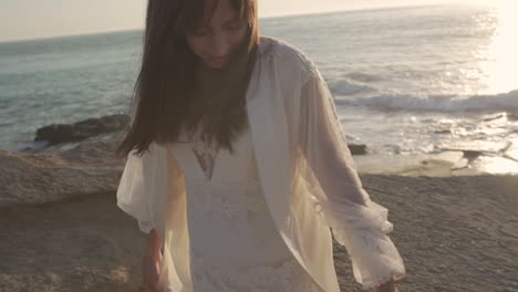 Romantic-bride-walking-on-sandy-beach