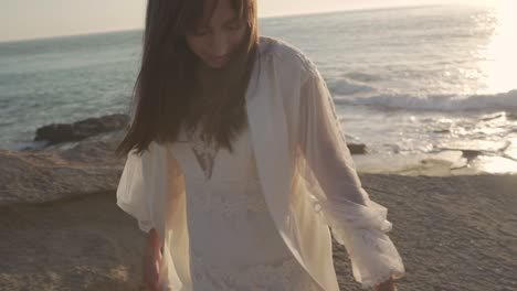 romantic bride walking on sandy beach