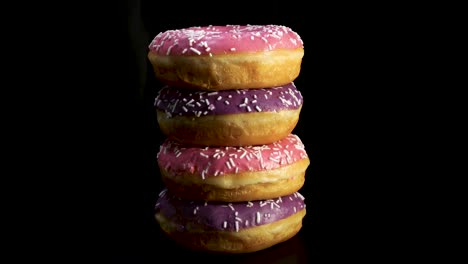 donut sabroso en primer plano girando contra un fondo negro