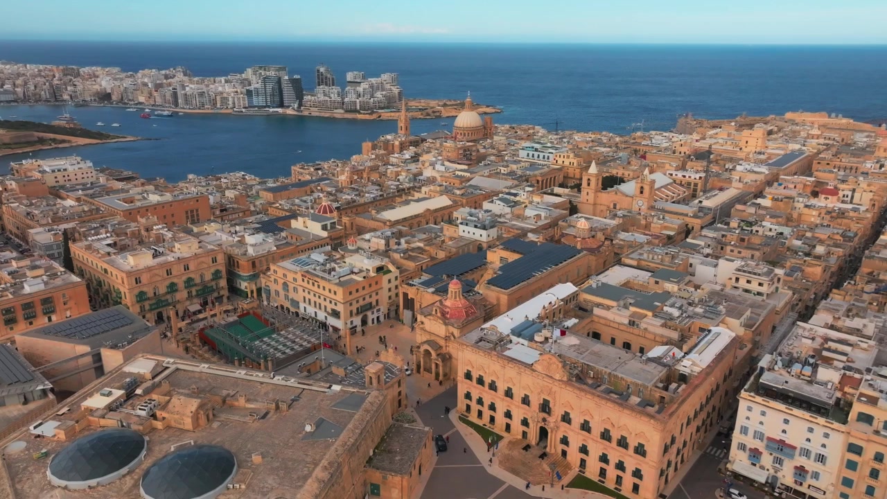 Filmato aereo che mostra lo storico paesaggio urbano di La Valletta sul mare, catturando dettagli architettonici