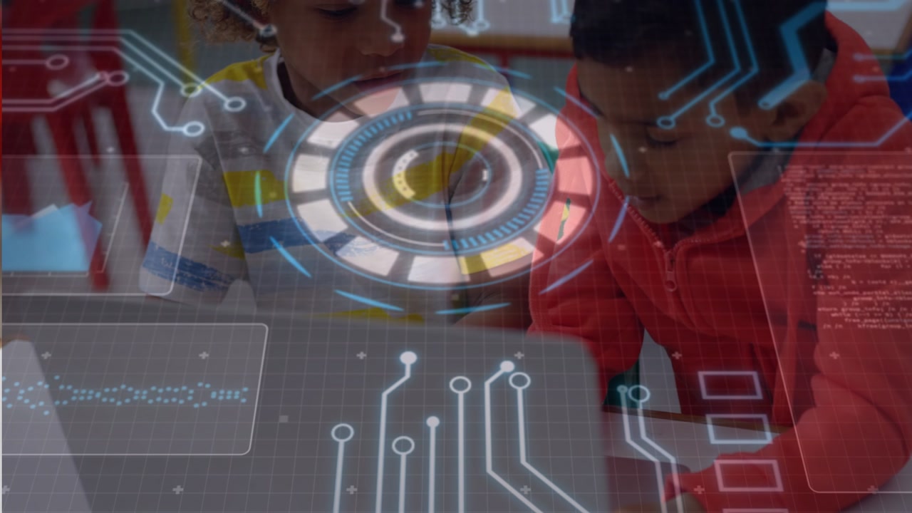 Two boys placing hands on laptop keyboard, right child initiating HUD animation for class work