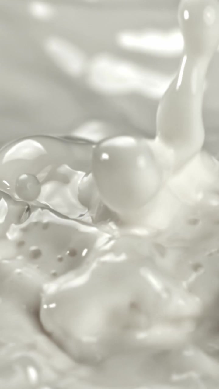 Close-up of Creamy White Liquid Splashing in Slow Motion