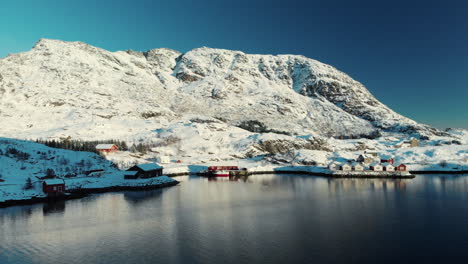 Drone-shot-of-a-fishermen's-house-in-lofoten-near-a-lake