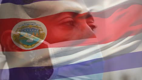 Animation-Der-Flagge-Von-Costa-Rica,-Die-Während-Der-Covid-19-Pandemie-über-Einem-Mann-Mit-Gesichtsmaske-Winkt