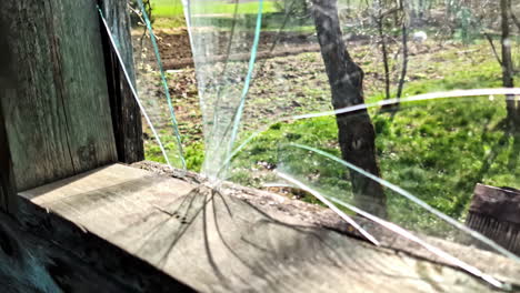 closeup of cracked window pane in old wooden frame