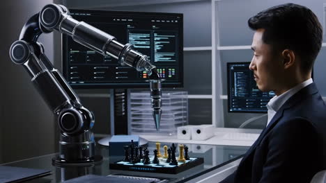 a man plays chess against a sophisticated robotic arm