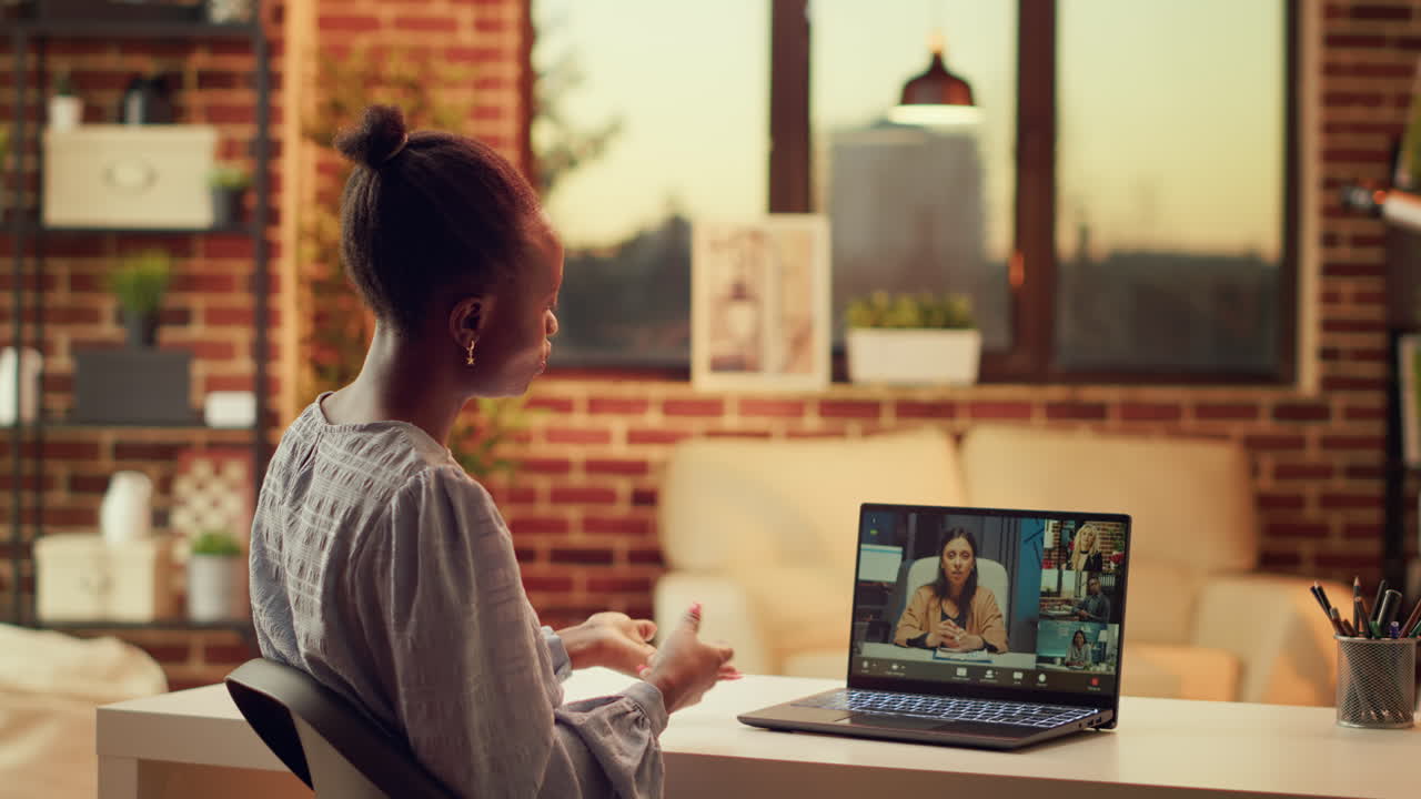 Worker chats with clients on videocall