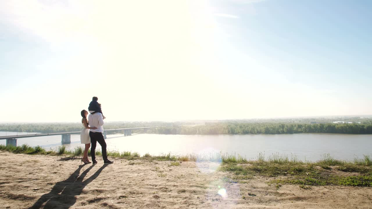 Family enjoying a scenic view by the river