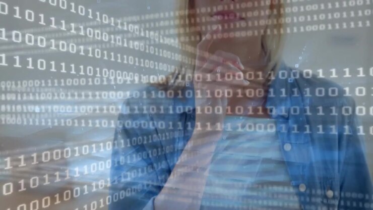 Tech professional tapping and swiping tablet causing binary overlay across face, contemplating data
