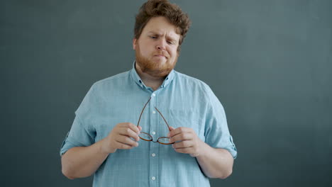 surprised man holding glasses