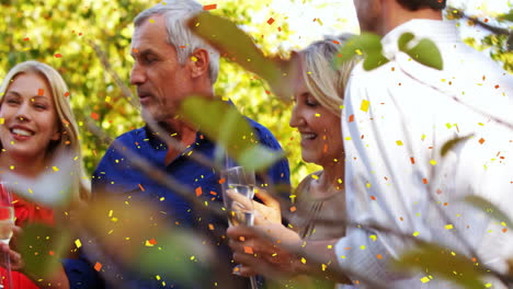 confetti animation over group of people celebrating outdoors with drinks