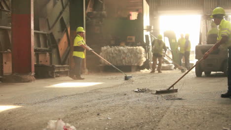 a skip loader picks up trash at a recycling center 2