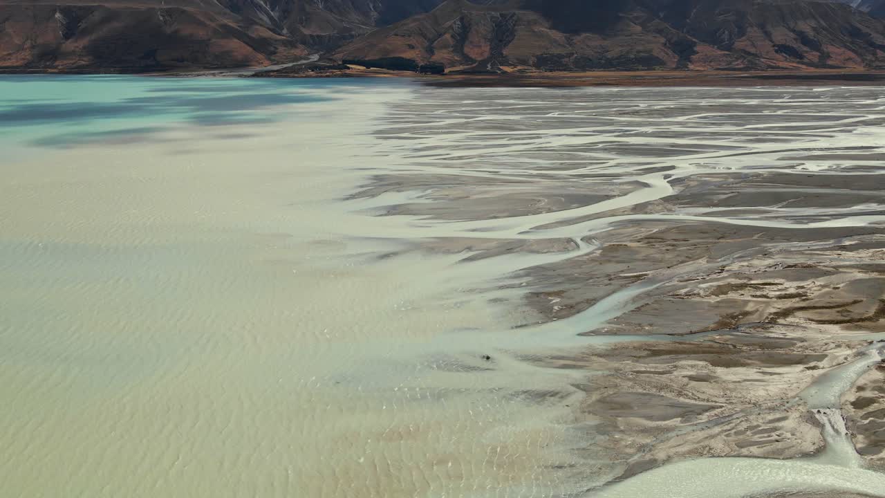 Cinematic aerial view over Tasman river delta entering Lake Pukaki