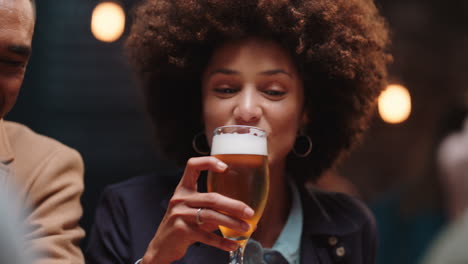happy group of friends making toast having fun drinking socializing hanging out at pub chatting sharing celebration enjoying evening reunion gathering