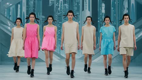 an elegant fashion showcase featuring a diverse group of models walking down the runway in vibrant dresses, capturing contemporary trends and style in motion