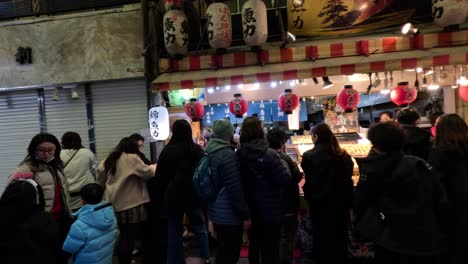 crowded outdoor market with vibrant lanterns