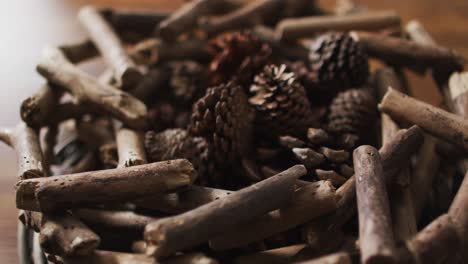 video of christmas decorations with pine cones on wooden background