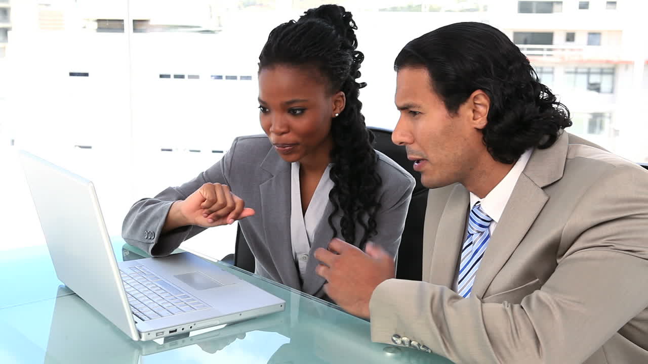 Business partners sitting with a laptop