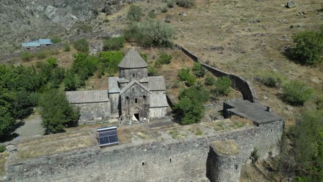 Aerial-orbits-ancient-Apostolic-church,-monastery-in-rugged-Armenia