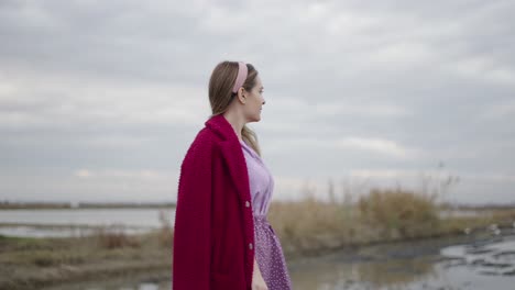 woman in red coat and purple dress outdoors