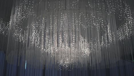 Stunning-ceiling-installation-with-cascading-lights,-creating-a-starry-effect