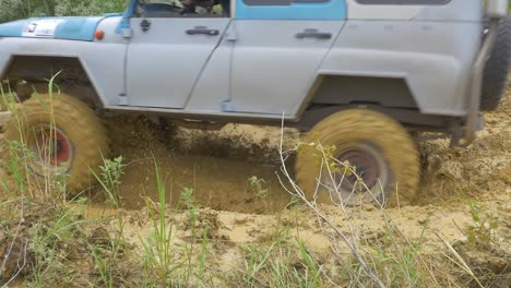 off-road vehicle driving through deep mud