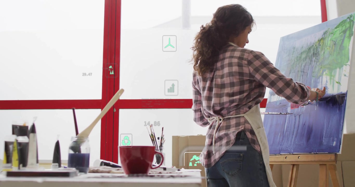 Woman in art studio blending paint to monitor progress with animated metrics appearing on window