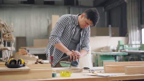 carpenter sanding wood