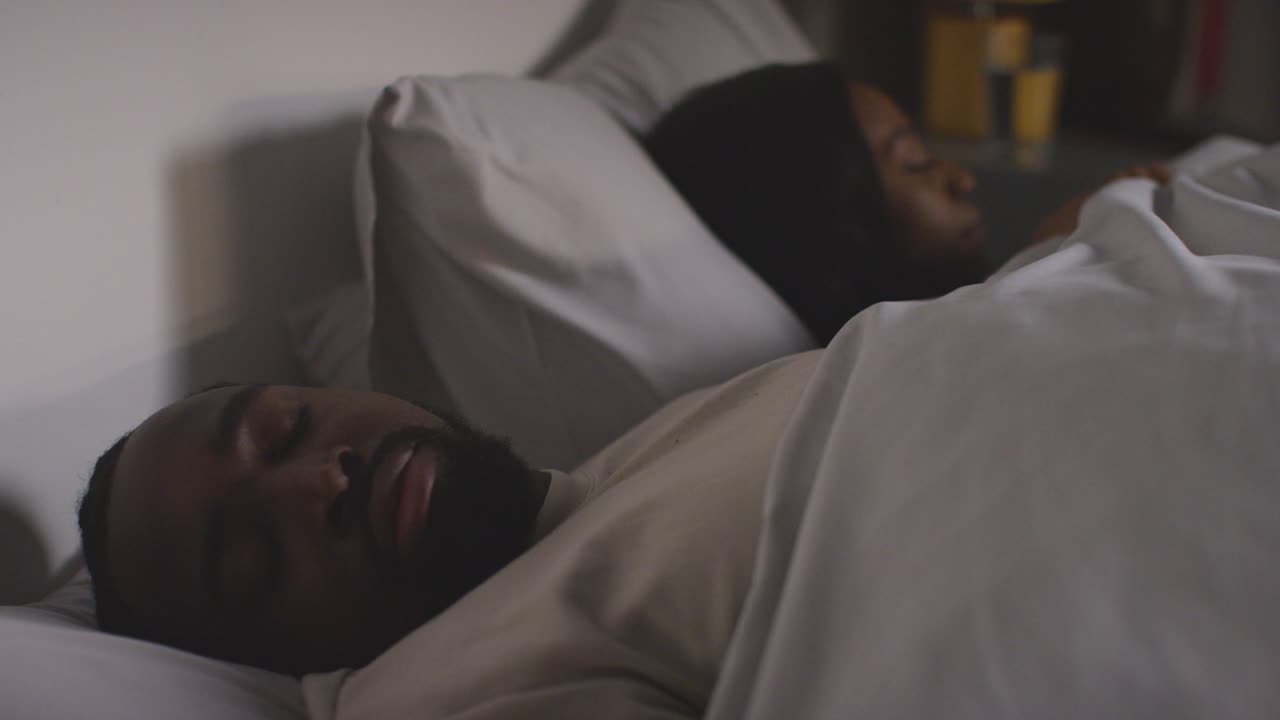 Close Up Of Loving Couple Lying Asleep In Bed At Home At Night 1