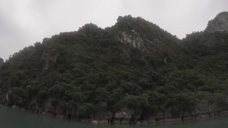 an-karst-island-nestled-within-the-stunning-Halong-Bay-in-Vietnam,-captured-using-a-GoPro-from-a-kayak