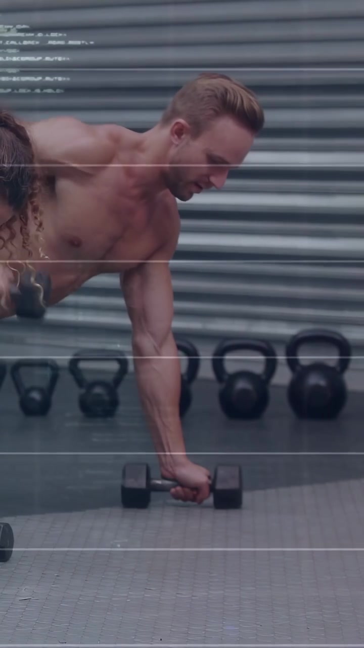Vertical video: Man grabbing hex dumbbell, doing plank rows for fitness as overlay intensifies