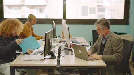 diverse coworkers working in a shared table in a coworking