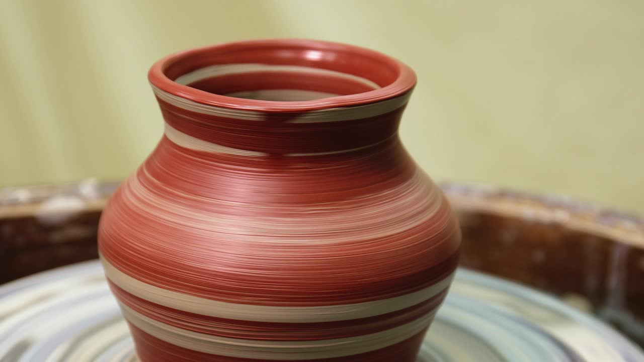 Pot rotating on pottery wheel. Just painted with brush