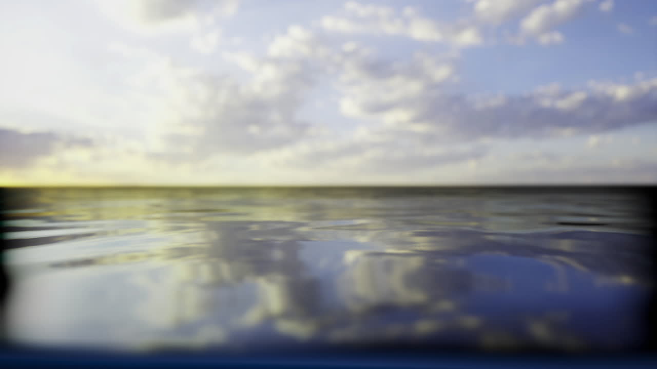 Expansive view of calm water reflecting a colorful sky at sunset