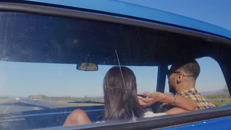 young couple on a road trip in their pick-up truck