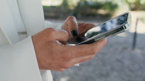 lady hands scrolling cell phone searching information in internet close up.